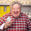 a man wearing a red checked shirt holds a ball of aluminium foil