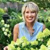 woman with short blonde hair in a large flower garden