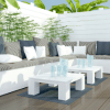 outdoor patio with large white outdoor seating and plants