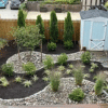 a garden with decorative stones and plants
