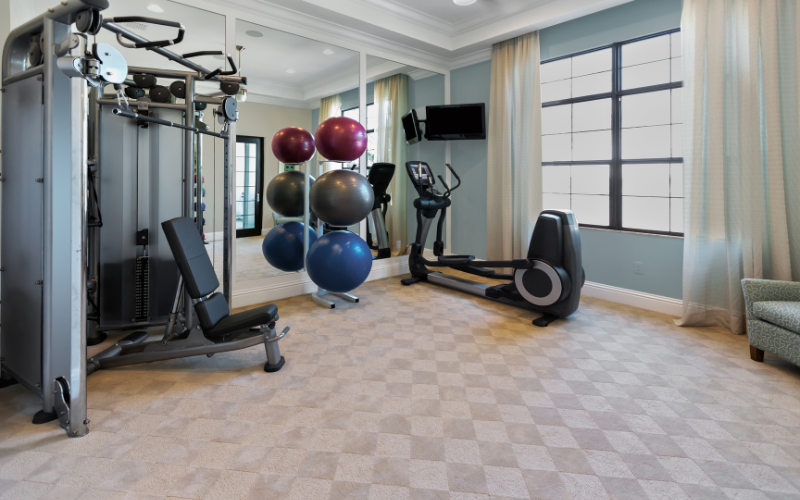 Bedroom home gym on brown checkered carpet