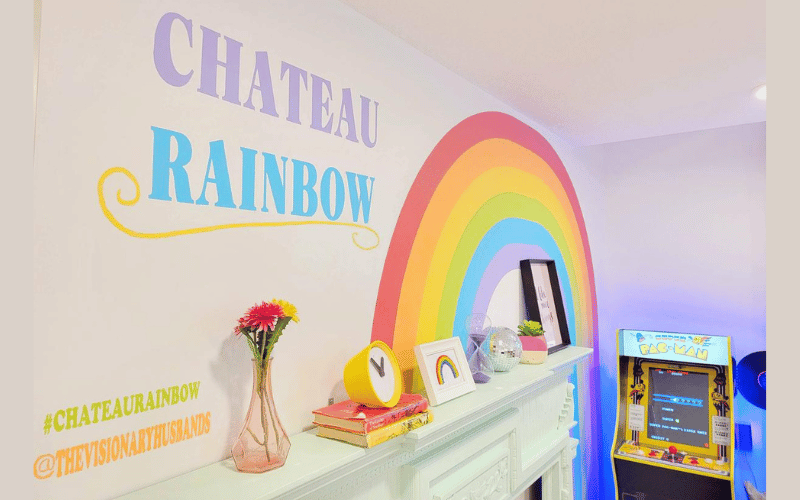 Chateau Rainbow room off white walls with a rainbow and retro pacman arcade game