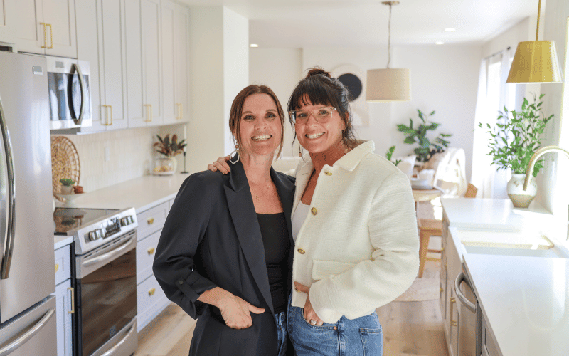 Leslie Davis and Lyndsay Lamb standing in a kitchen smiling at the camera