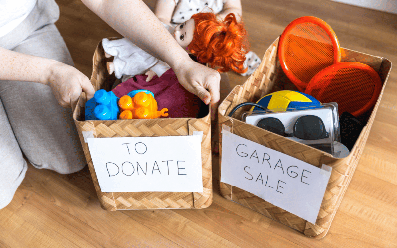 Two baskets - to donate and garage sale, full of stuff on hardwood floor