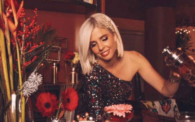 Bugsy Drake sitting at a table with flowers and candles
