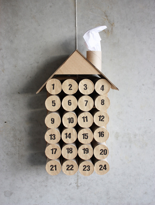 Advent calendar shaped like house, made of toilet paper rolls